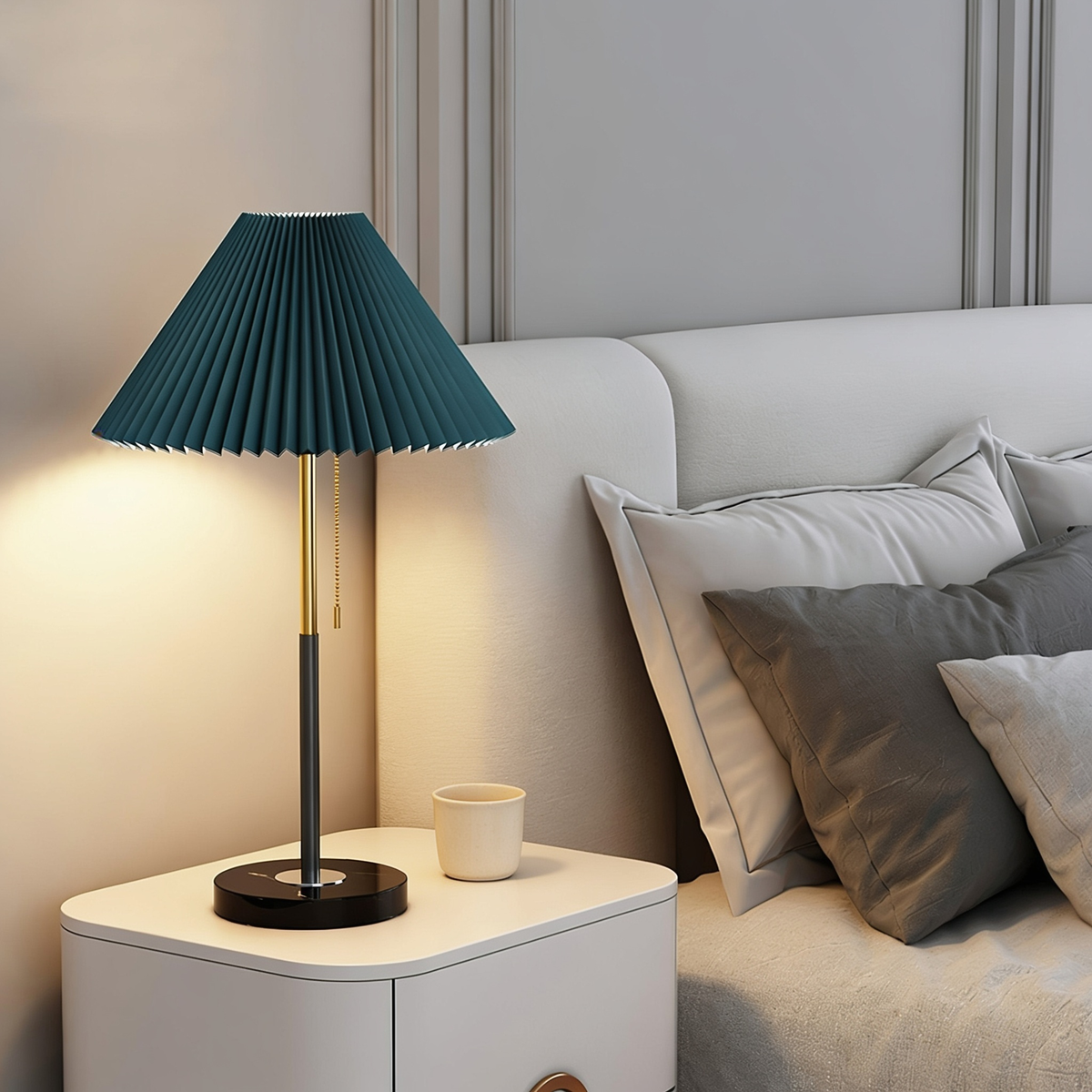 Mathella Table Lamp in green with pleated shade and brass and black stem on a bedside table