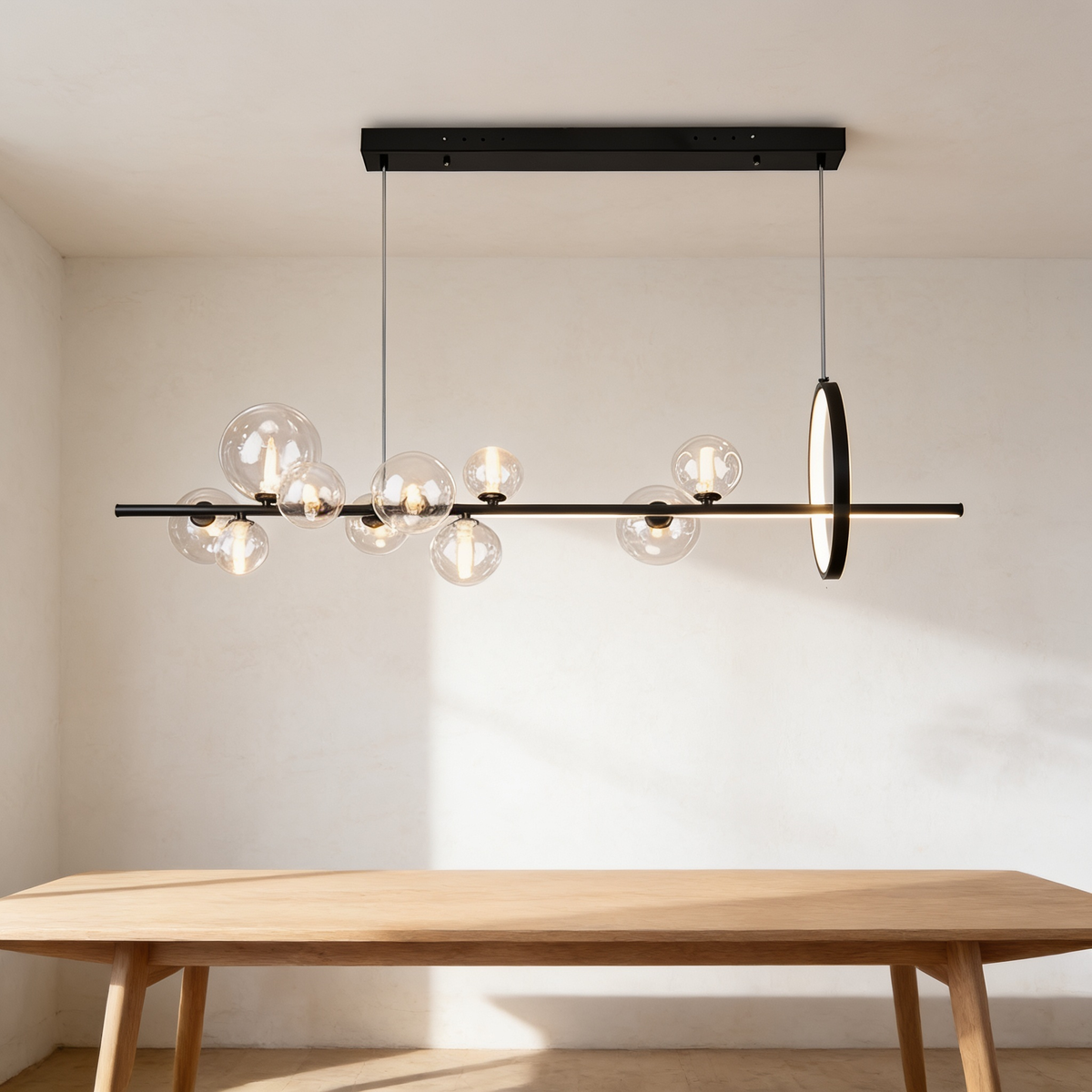 Mivaryn Chandelier, black bar with clear glass globes and an upright ring above a dining table