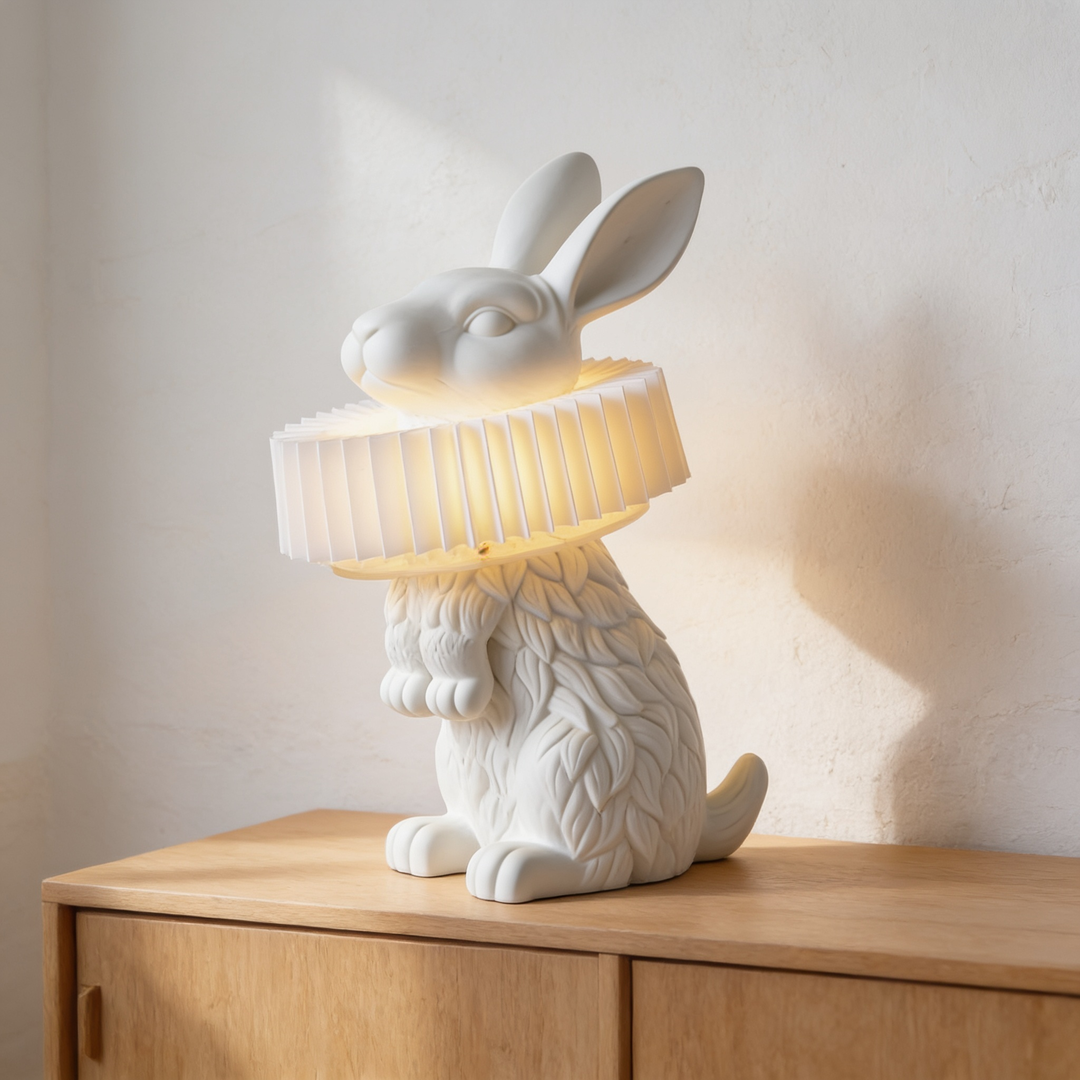 Rabellin Table Lamp, white rabbit with a pleated collar shade on a wooden sideboard