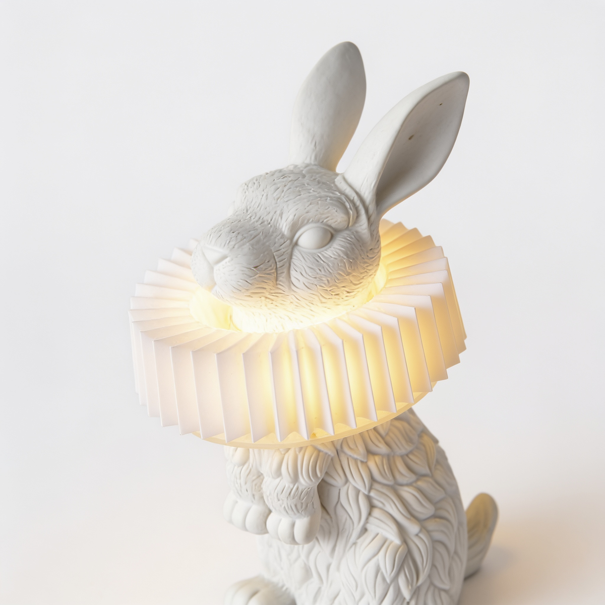 Rabellin Table Lamp, standing white leaf-textured rabbit with a lit pleated collar shade