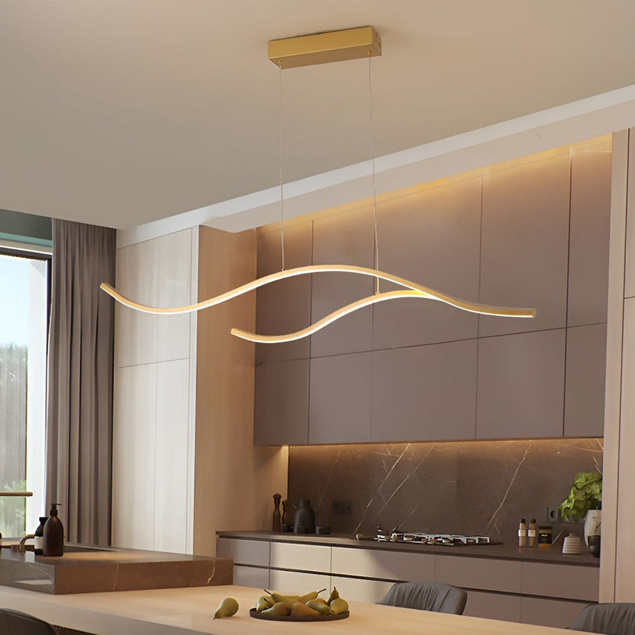 Linear pendant light made of wavy LED bars hung from a slim rectangular canopy, lit, above a kitchen counter beside a window.