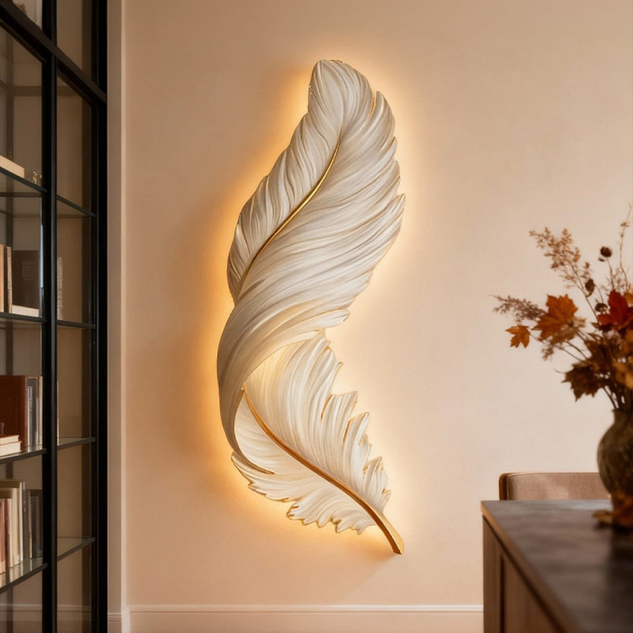 Comvilo Feather Wall Lamp in white and gold, mounted vertically and lit in a modern living room