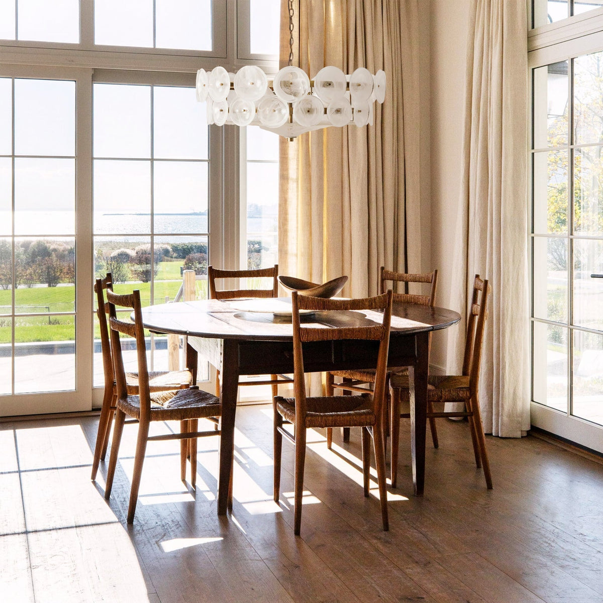 Disquelle Glass Disc Chandelier, White unit over dining table, sea-view windows