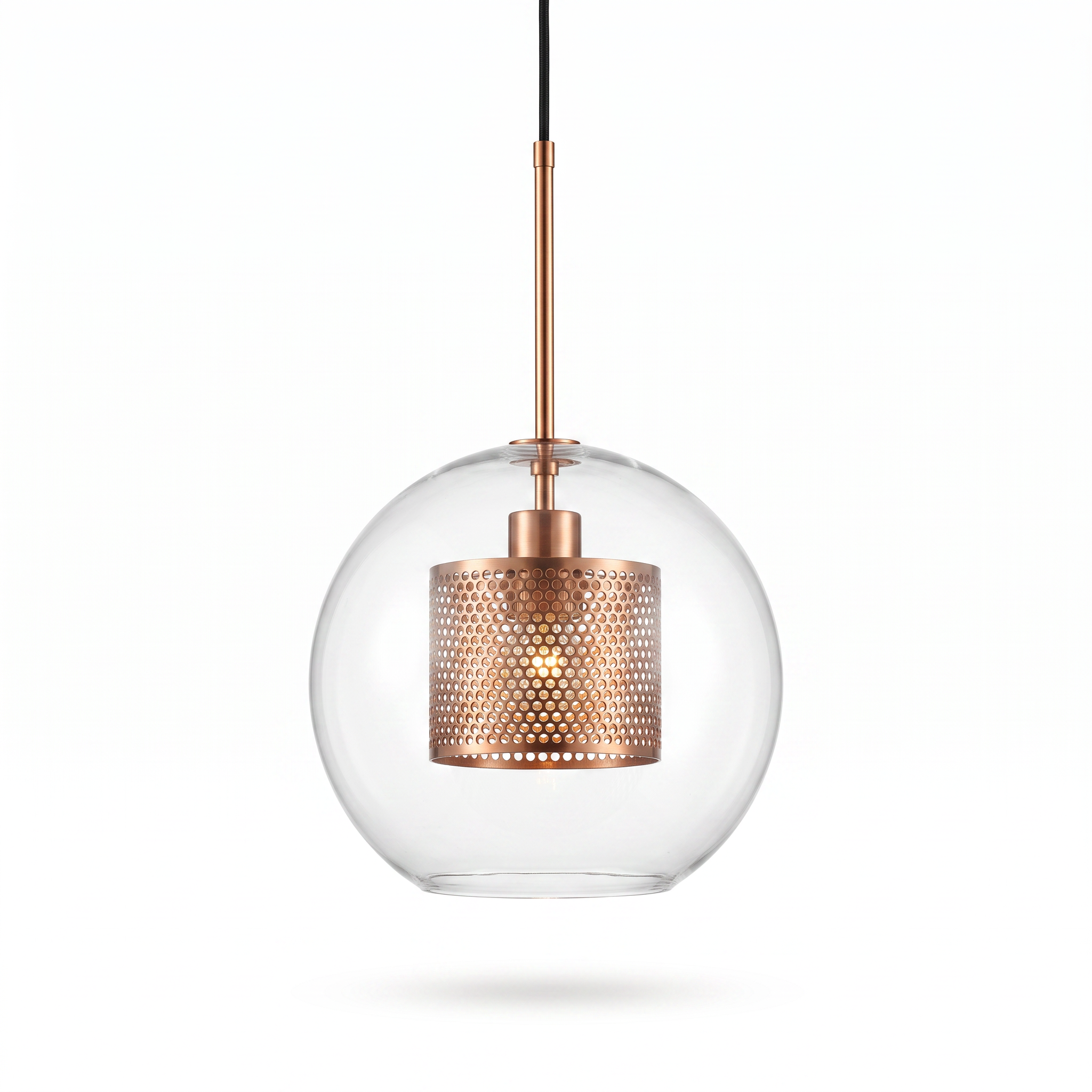 Comvilo Chiswick Glass Pendant Light: clear glass sphere with copper perforated inner drum, front studio view on white