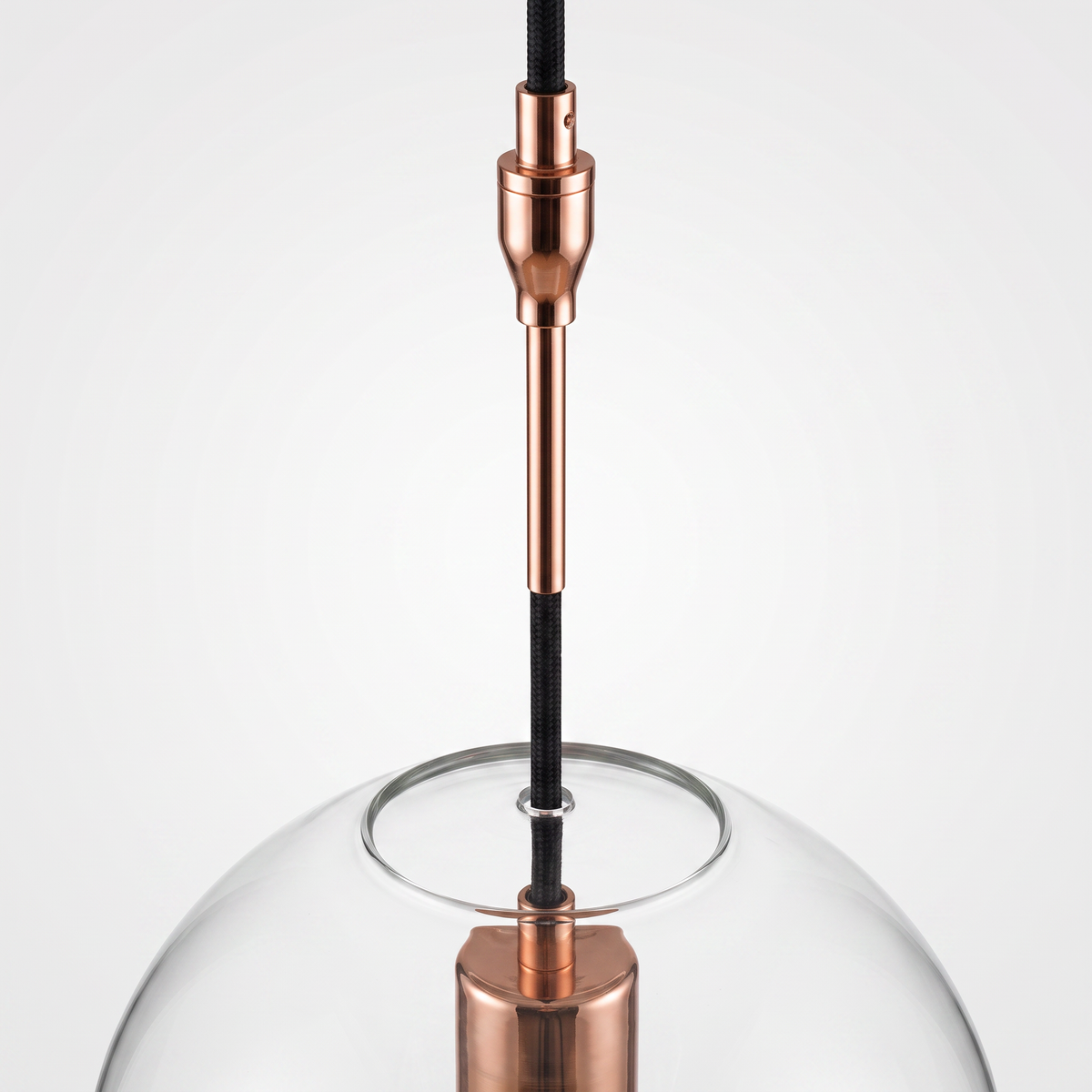 Detail of the copper suspension stem and cord connection above the glass sphere