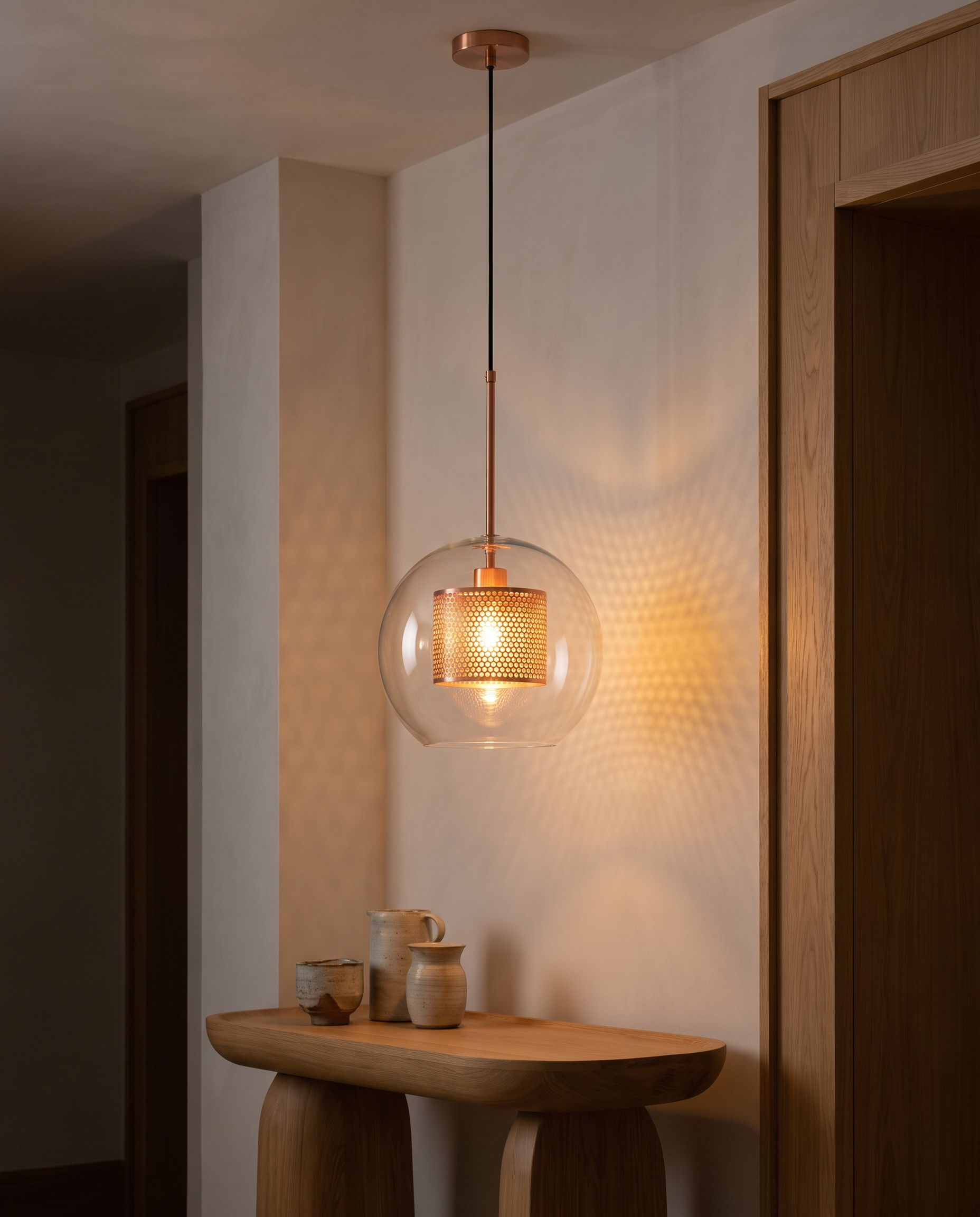 Chiswick Glass Pendant Light glowing warm at night over a side table