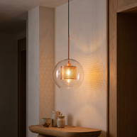 Chiswick Glass Pendant Light glowing warm at night over a side table