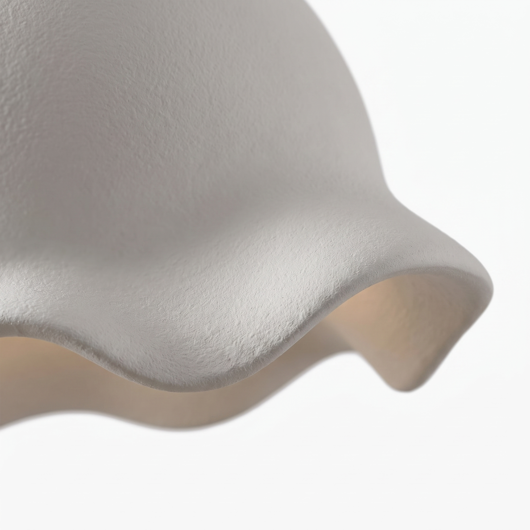 Macro detail of the sculptural cloud shade's matte white wavy rim