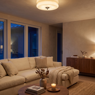 Marais ceiling light glowing warm in a living room at dusk