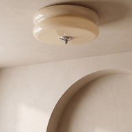 Low angle view of the Marais ceiling light near a plaster archway