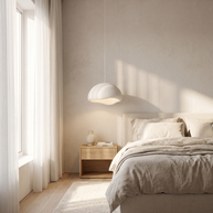 Nuvola cloud pendant in a bright quiet-luxury bedroom beside a platform bed