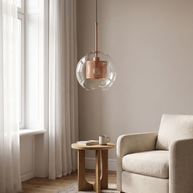Chiswick Glass Pendant Light at realistic scale beside an armchair and side table