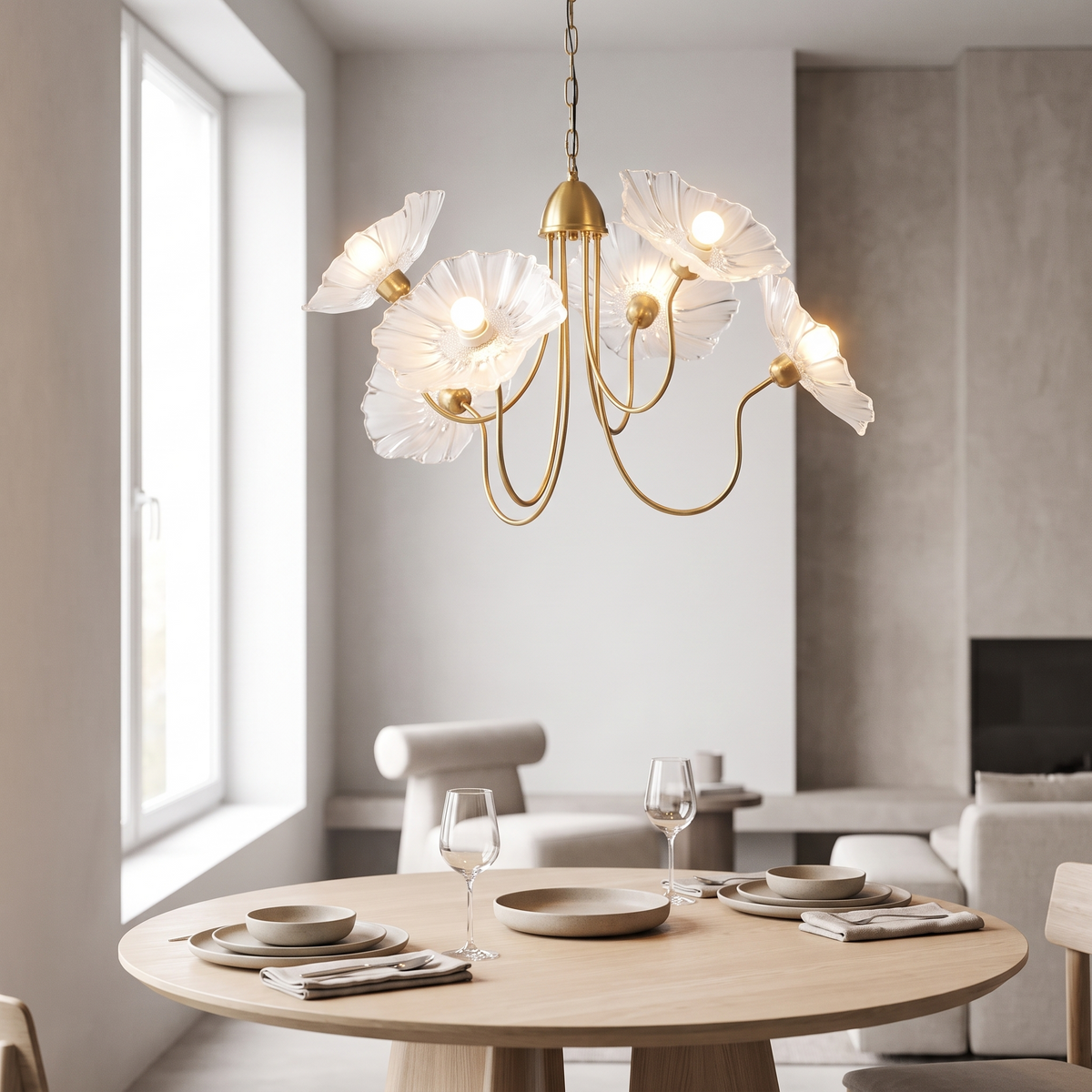 Fiorenza chandelier in the six-head form, gold frame with clear frosted leaf-shaped glass shades, hanging above a round pale-oak dining table set for two.