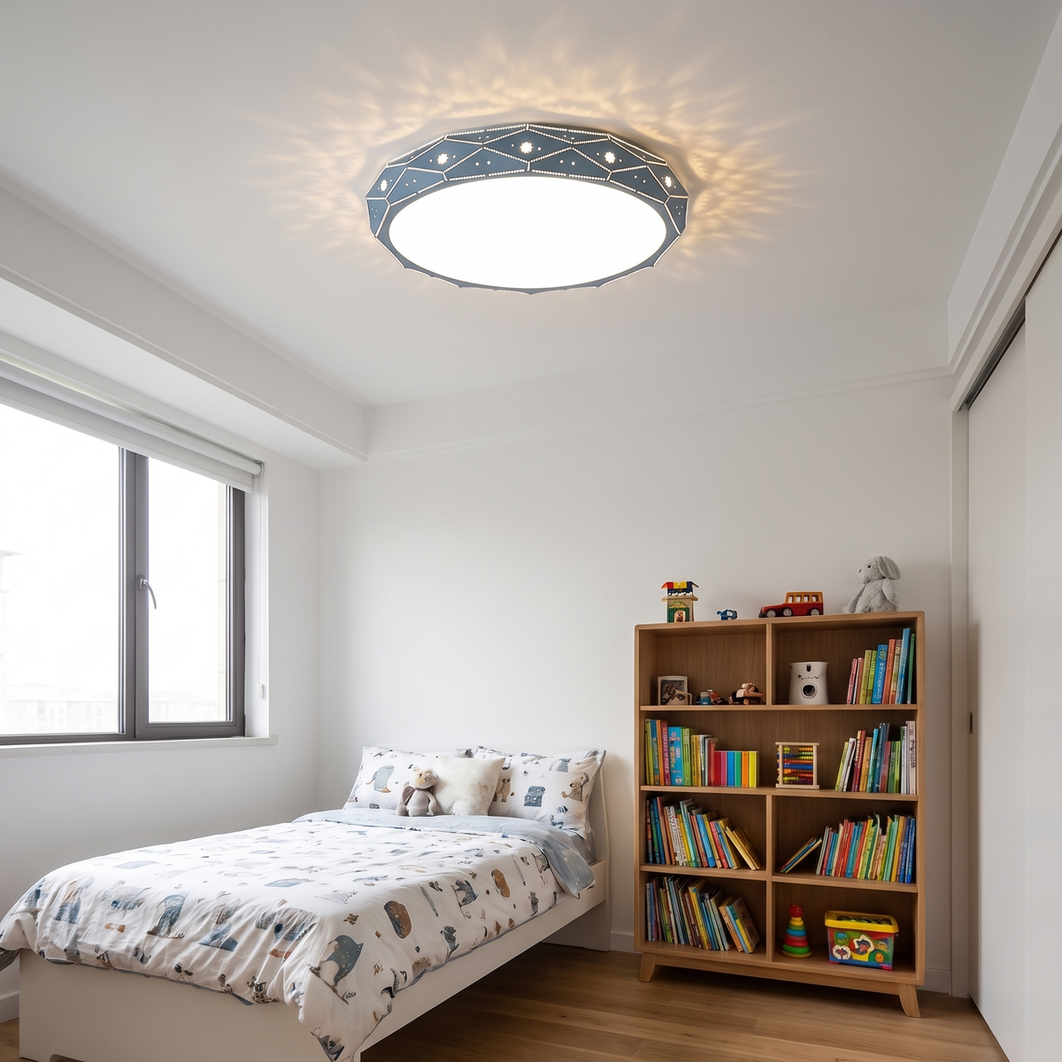 Merisse blue drum flush mount with a pierced faceted rim, sitting flush on the ceiling of a child's bedroom above a single bed and a bookcase.