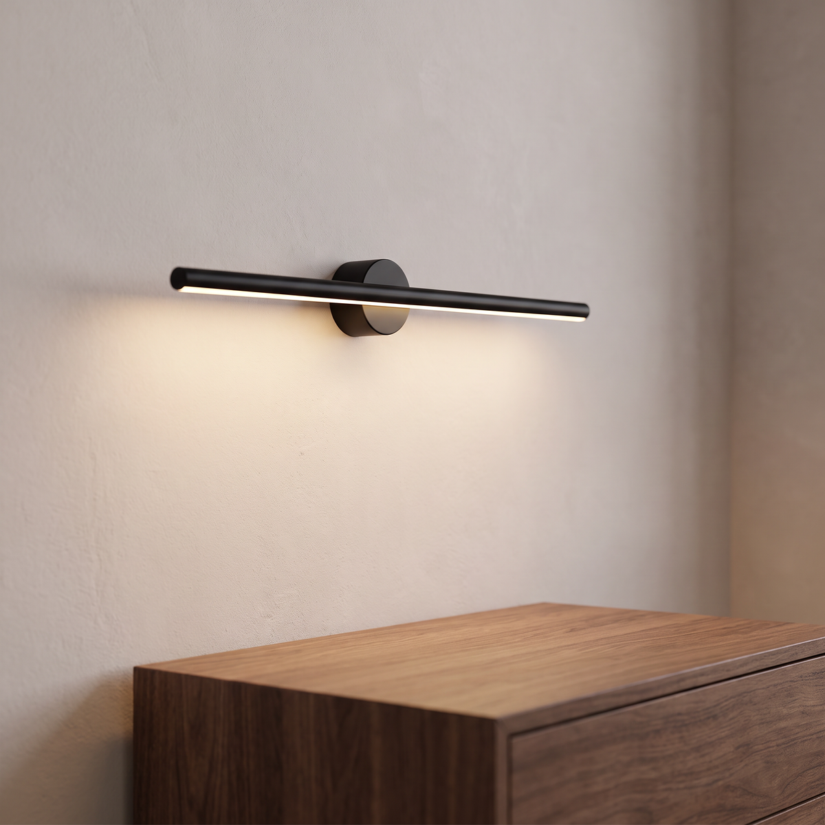 Tessane slim black linear wall light with a warm lit strip and a round backplate, mounted above a walnut sideboard.