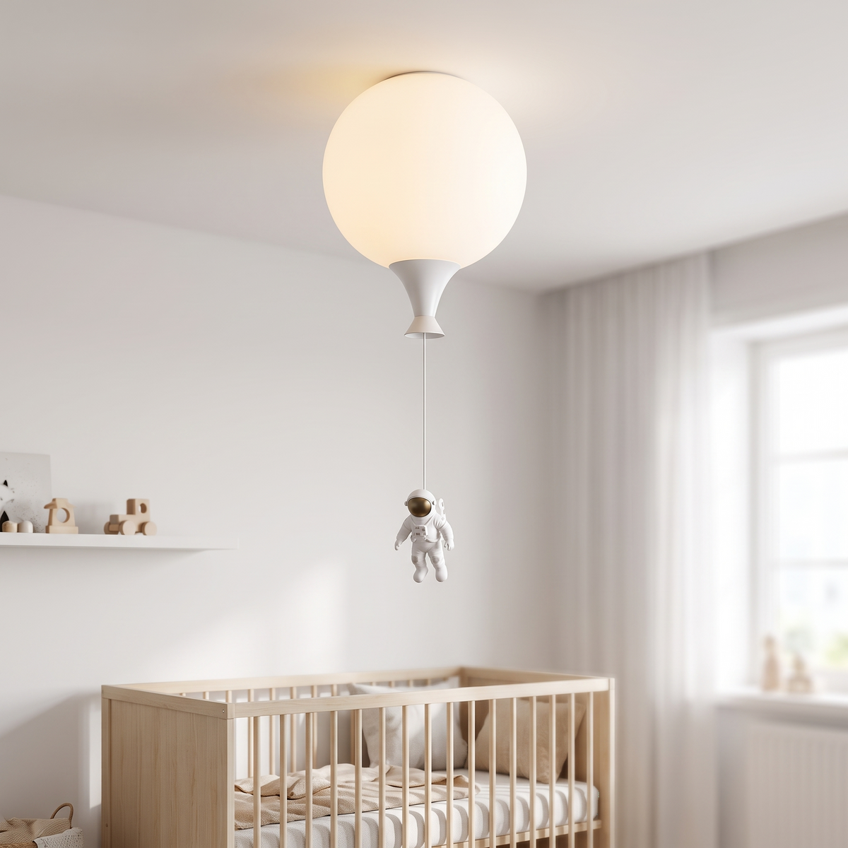 Palloma balloon ceiling light, a white spherical shade mounted flush on a nursery ceiling with a cone nozzle and a small white astronaut figurine hanging below on a cord.