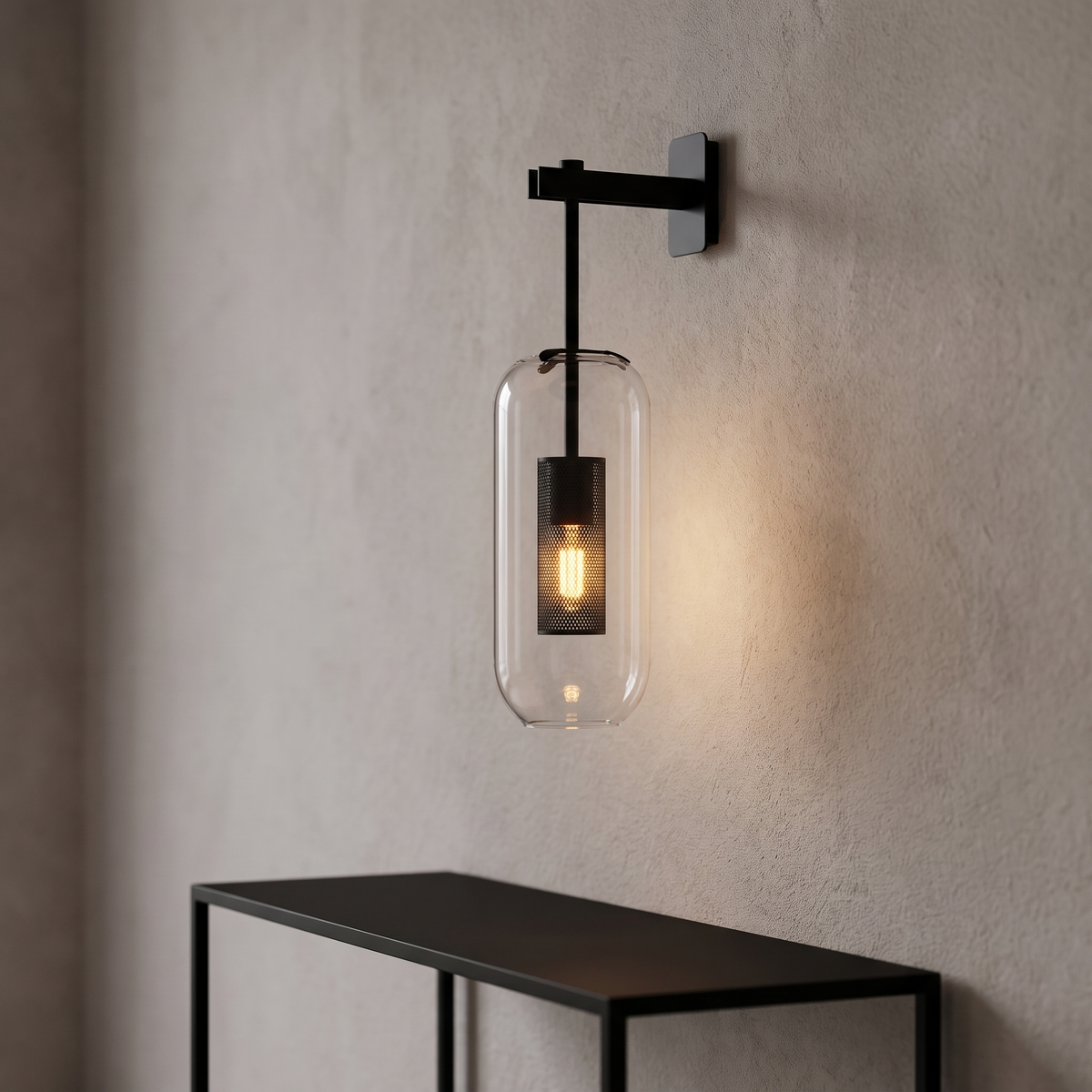 Sarnico wall lamp with a clear glass capsule on a black arm and square backplate, a black mesh cylinder lit inside the glass.