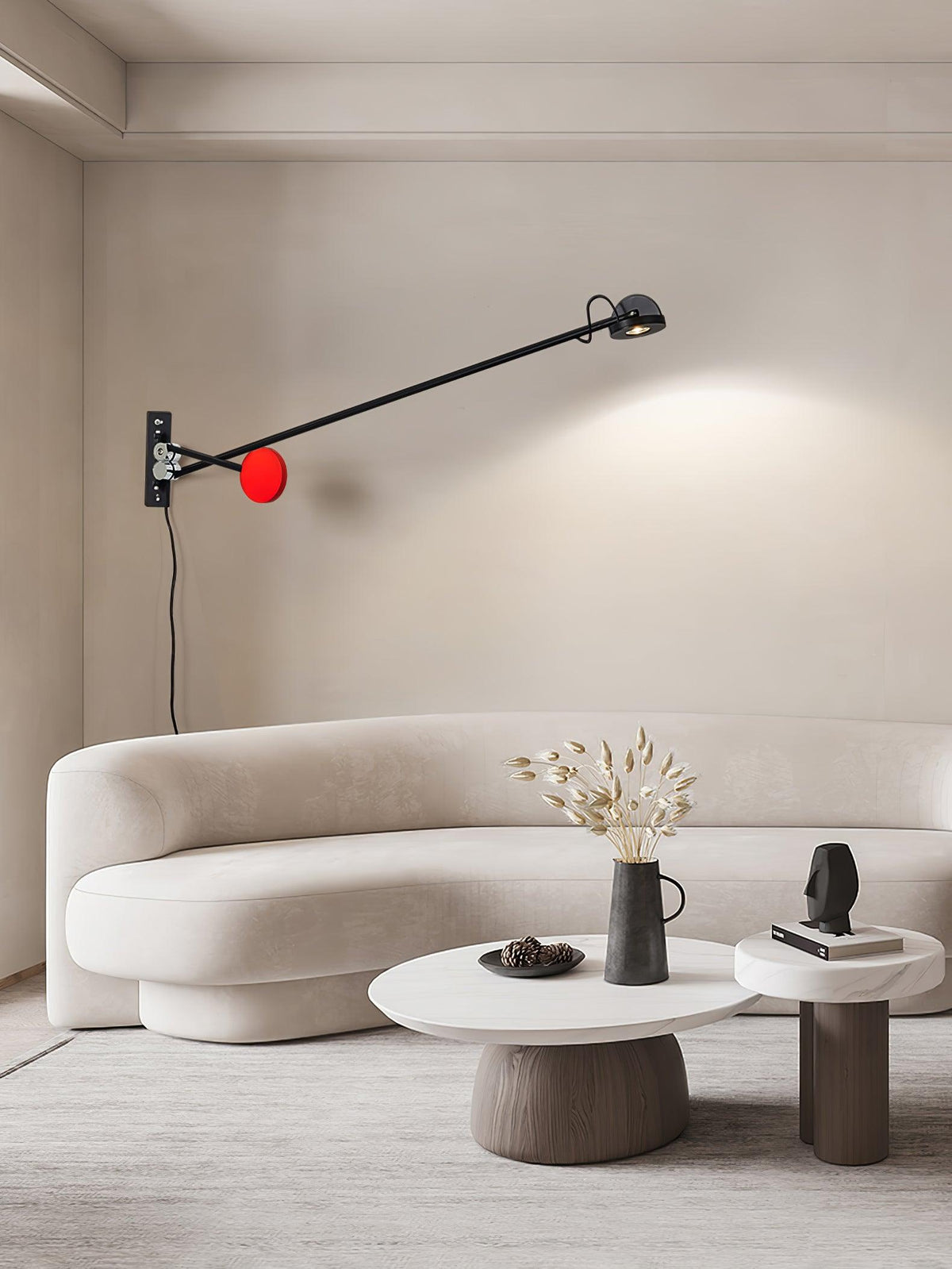 Libranne Adjustable Arm Wall Lamp, Black & Red lit over curved sofa, minimalist living room