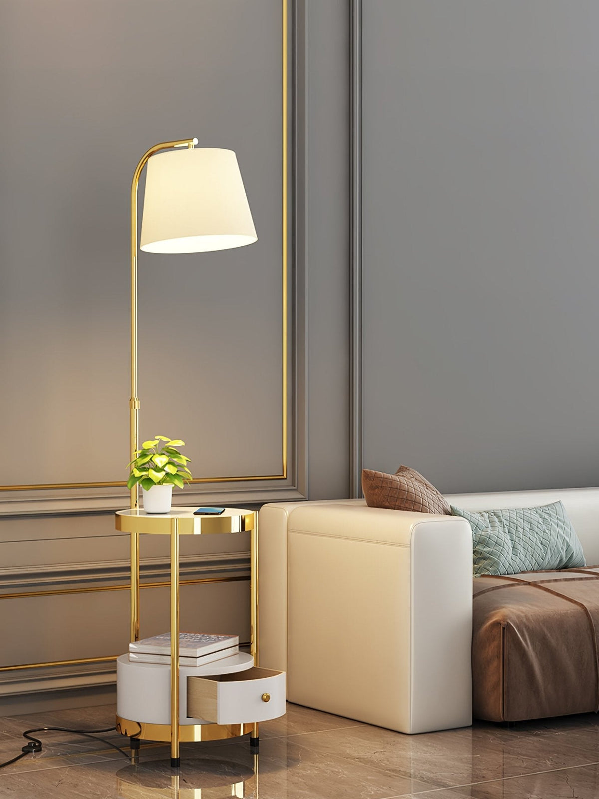 Lileth Floor Lamp in gold and white with open drawer, lit, beside a cream sofa in a paneled room