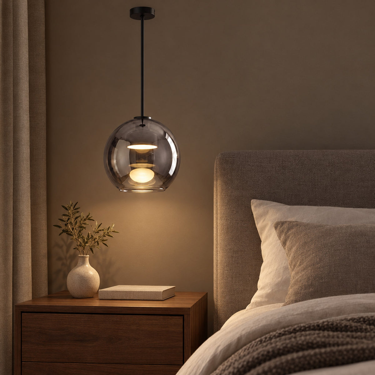 Metro Sphere Glass Pendant Lamp, hanging lit beside a bed above a walnut nightstand