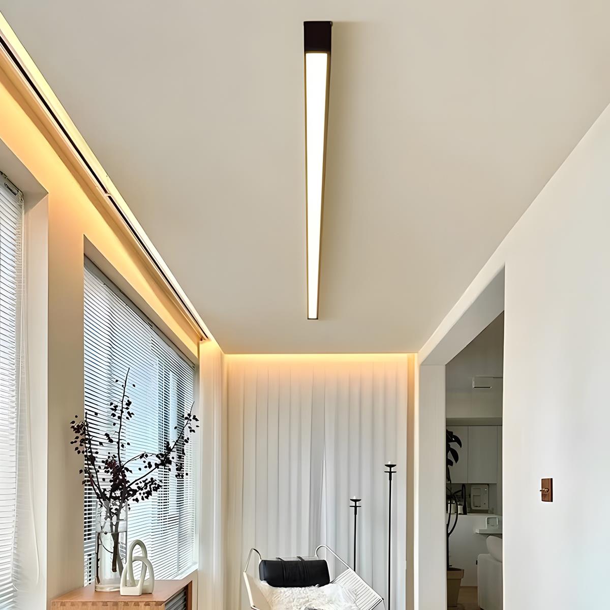 Slim linear ceiling light fitted along a hallway ceiling beside a window.