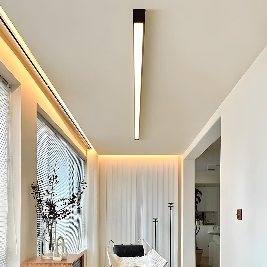Slim linear ceiling light fitted along a hallway ceiling beside a window.