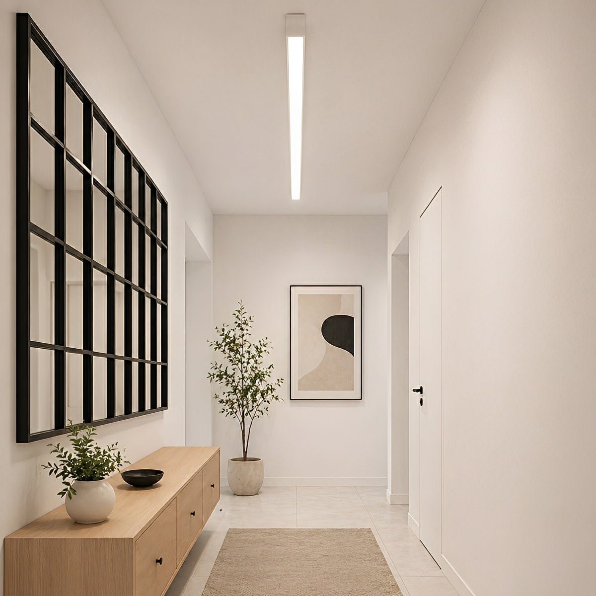 Slim linear LED ceiling light with a white body, fitted along a hallway ceiling.