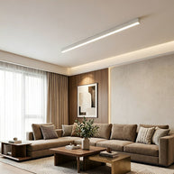 Slim linear LED ceiling light with a white body, fitted across a living room ceiling.