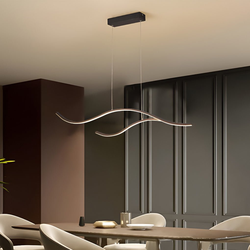Linear pendant light made of wavy LED bars hung from a slim rectangular canopy, lit, above a dining table in a room with dark panelling.