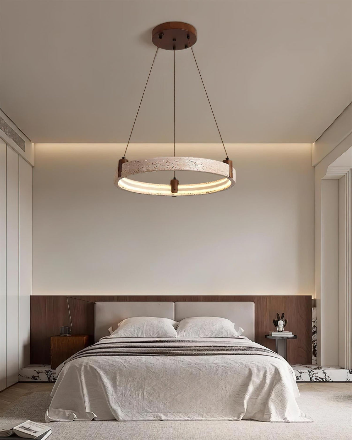Orbelline Travertine Orbit Chandelier, single ring lit over bed in bedroom