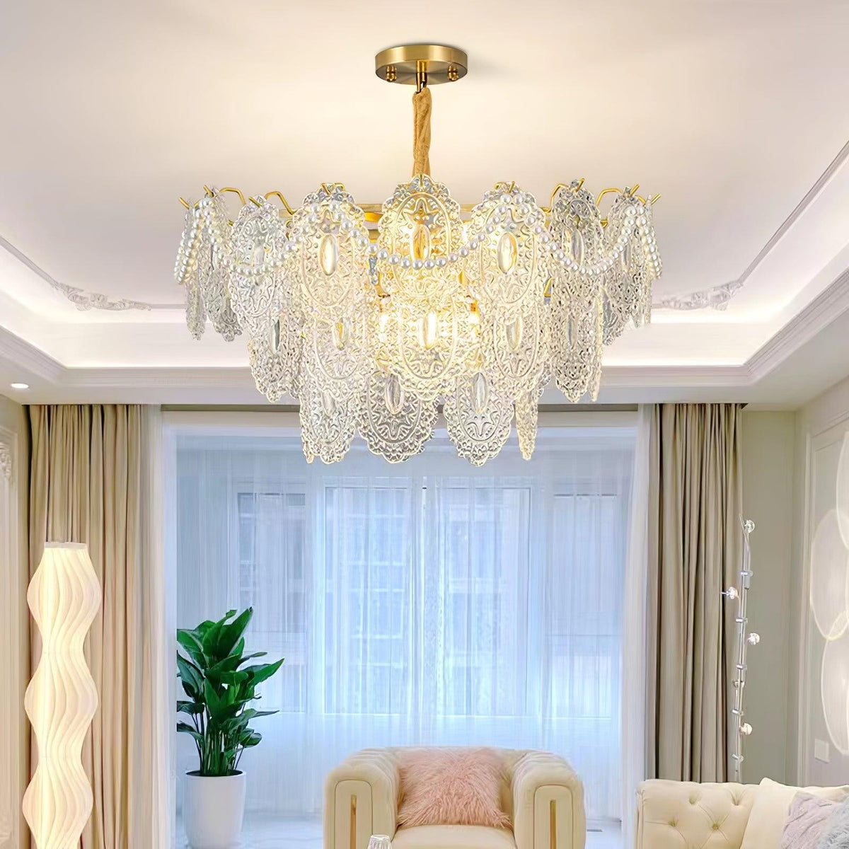 Perlova Pearl Glass Chandelier, lit over bright living room with sofa and window