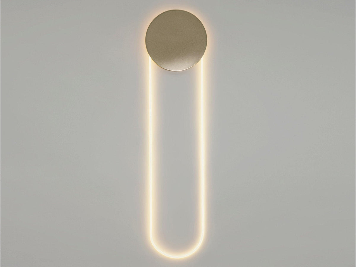 Ringelle Loop LED Wall Lamp, Gold disc and warm-lit white loop, plain grey wall