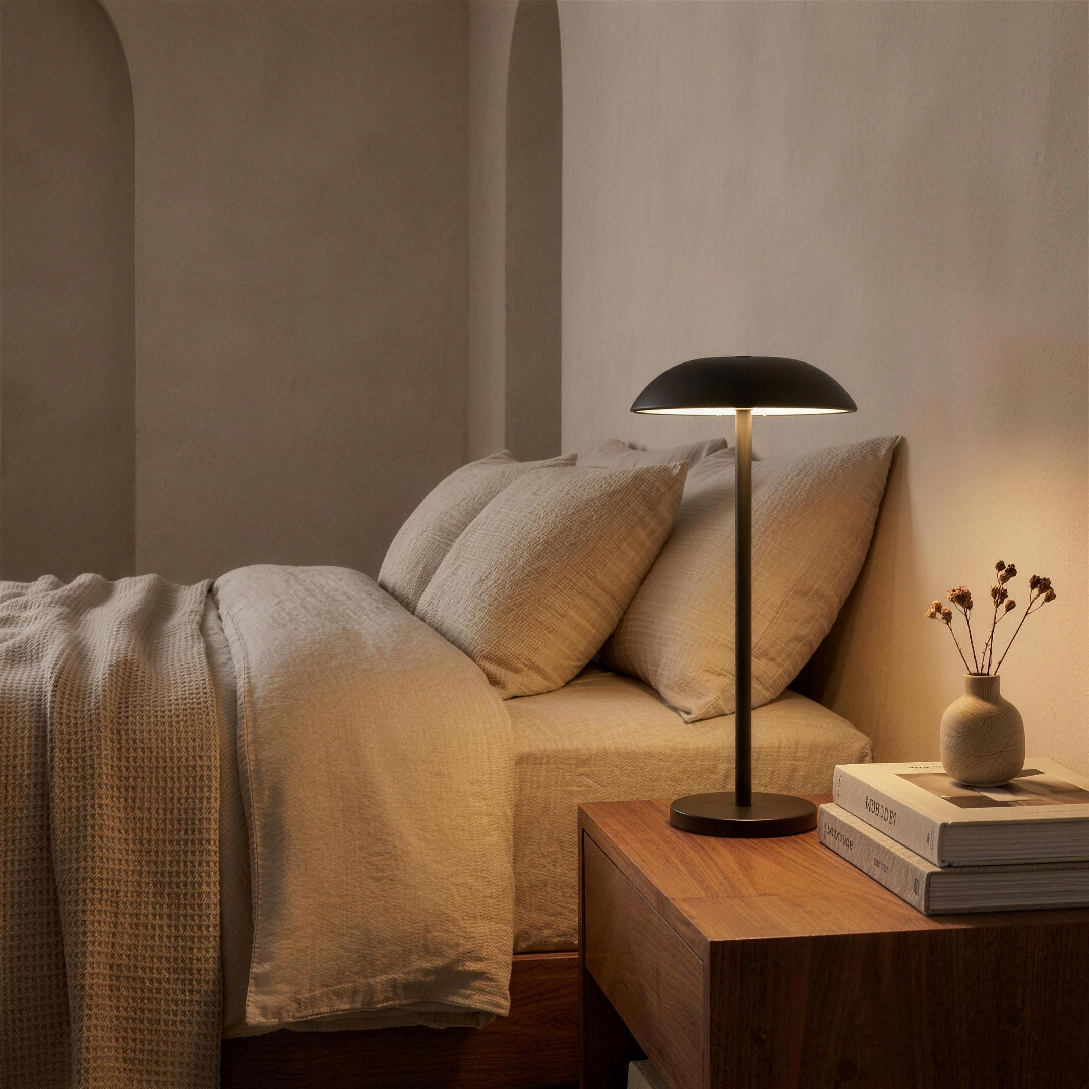 Sable rechargeable LED table lamp on a walnut nightstand in a warm-neutral bedroom