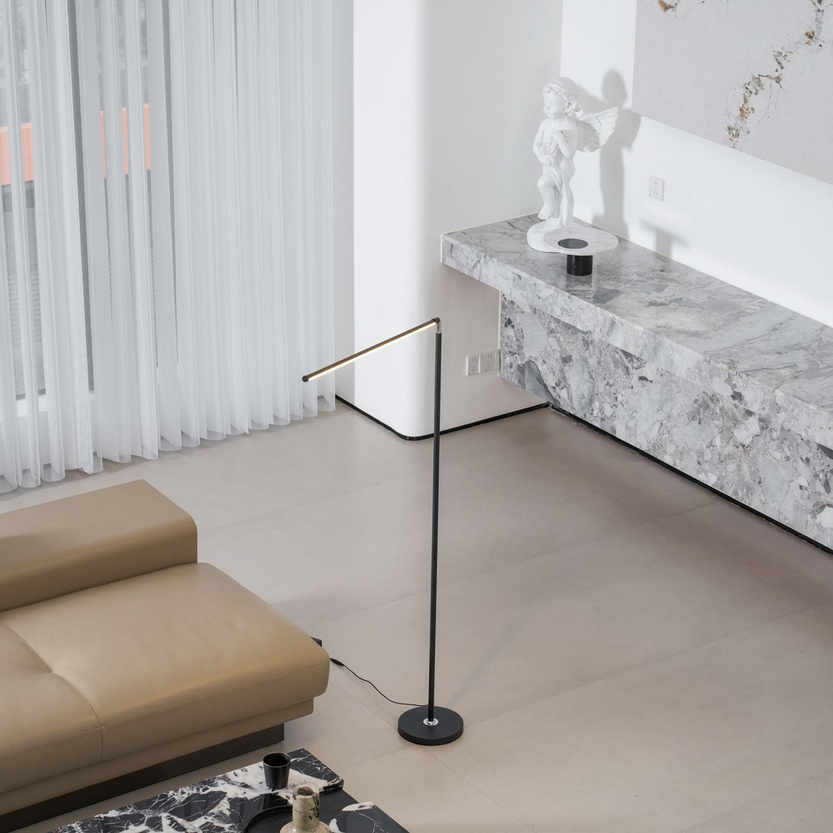 Slenna Slim Floor Lamp, Black lamp, overhead angle, living room with marble bench and statue