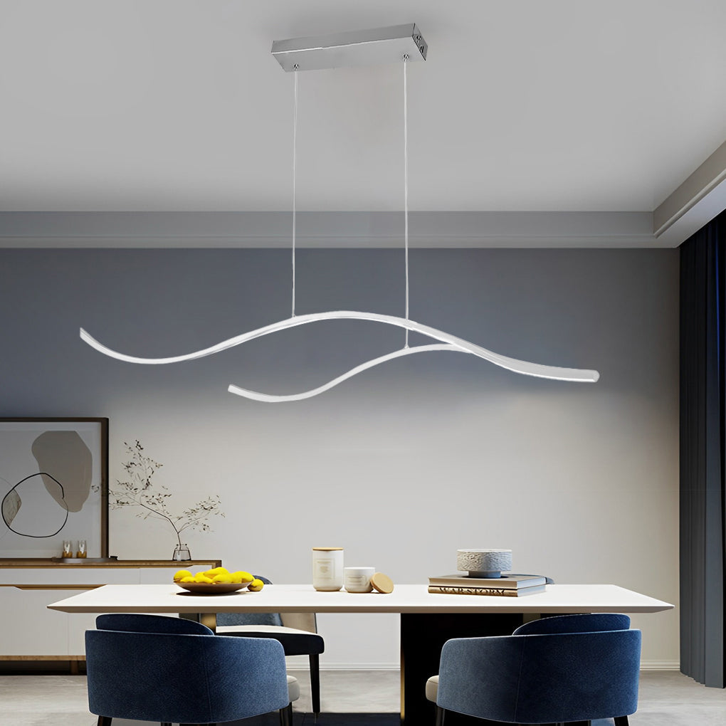 Linear pendant light made of wavy LED bars hung from a slim rectangular canopy, lit, above a dining table with blue chairs.