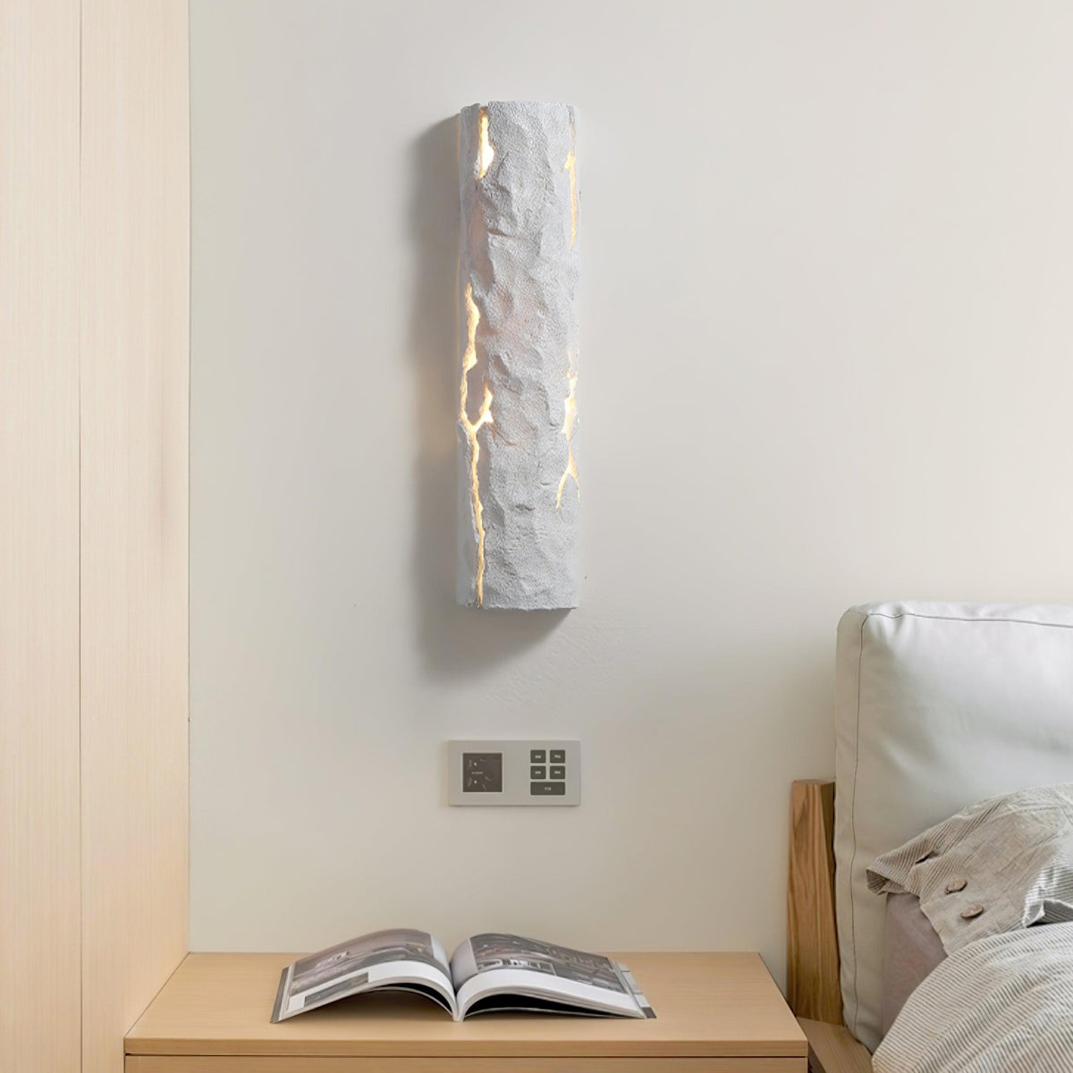 Sylvaren Bark Wall Light in white, lit on a bedroom wall above a nightstand