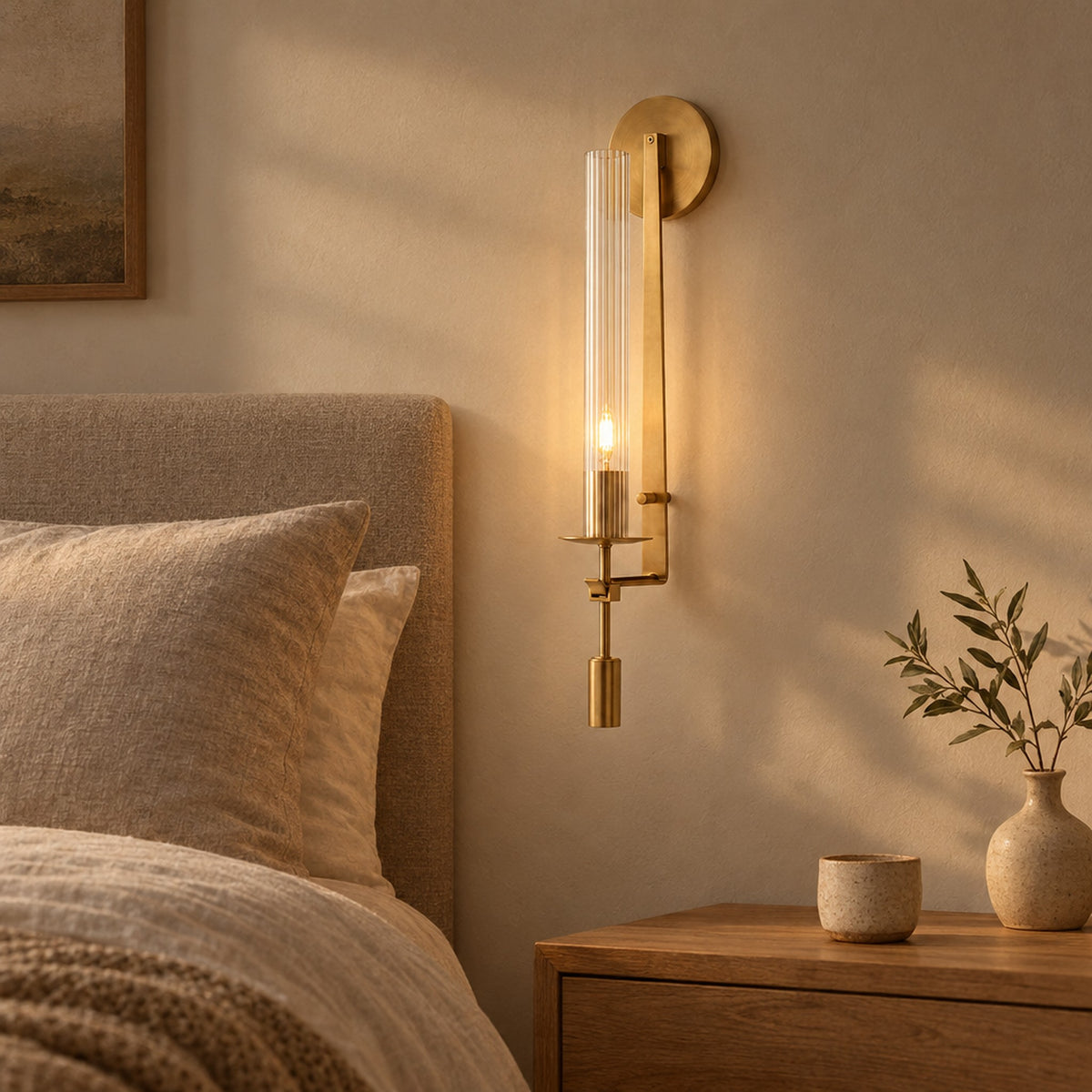Valenne Ribbed Glass Wall Sconce, lit beside a bed in a calm bedroom at dusk