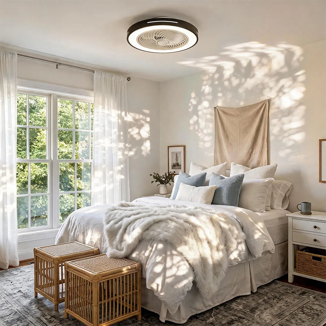 Ceiling fan with a black rim and integrated LED light, fitted flush to a bedroom ceiling in daylight.