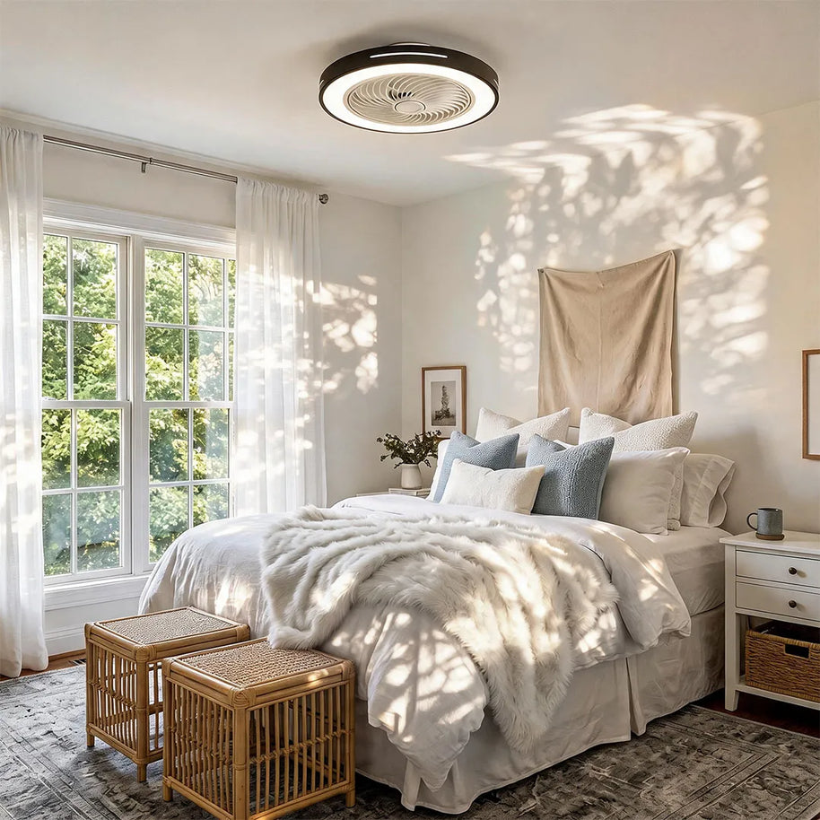 Ceiling fan with a black rim and integrated LED light, fitted flush to a bedroom ceiling in daylight.