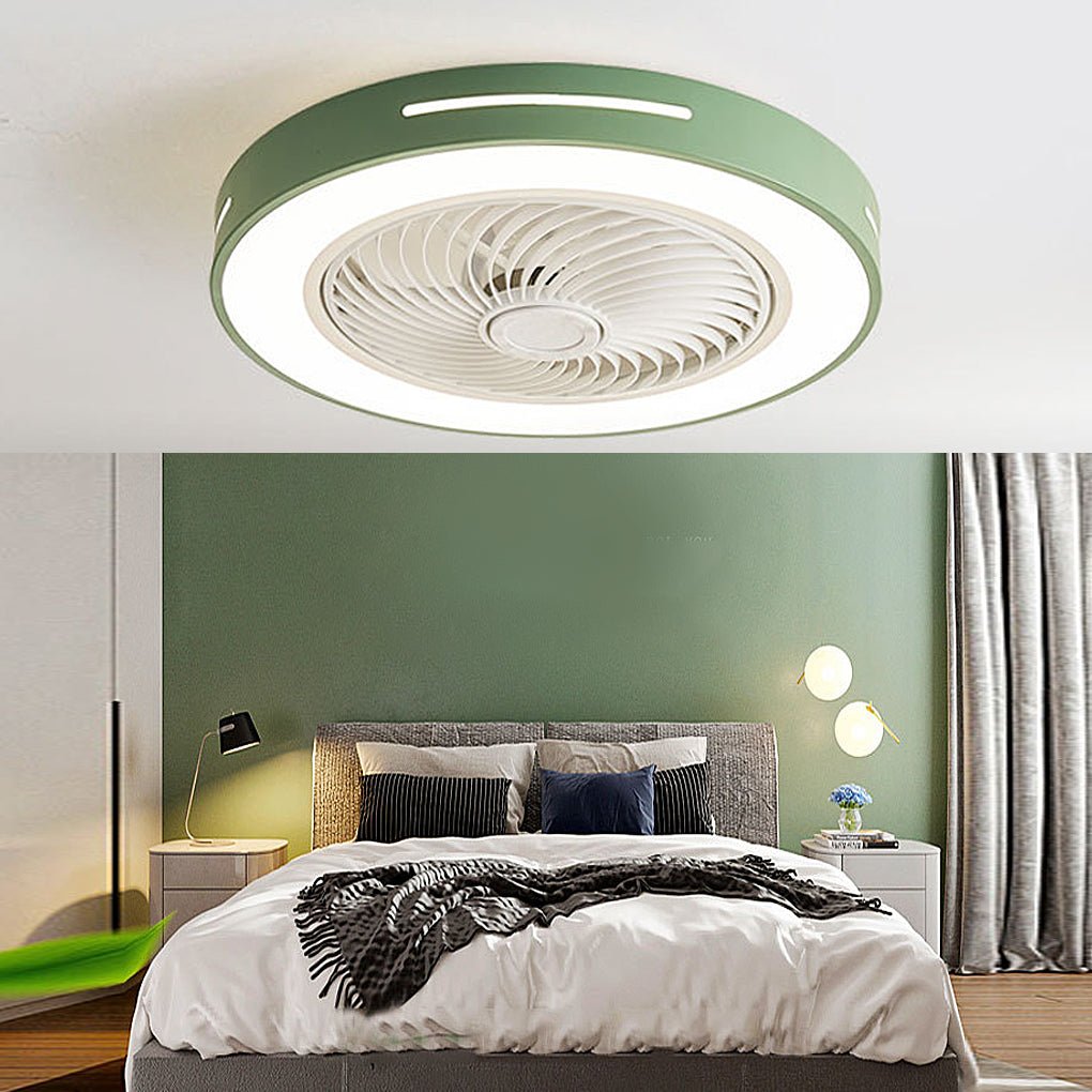 Flush-mount ceiling fan with an enclosed blade cage and a lit ring, green outer rim, fitted to a bedroom ceiling above a bed against a green wall.