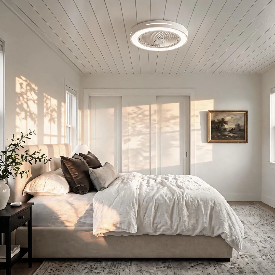 Ceiling fan with a white rim and integrated LED light, fitted flush to a white plank bedroom ceiling.